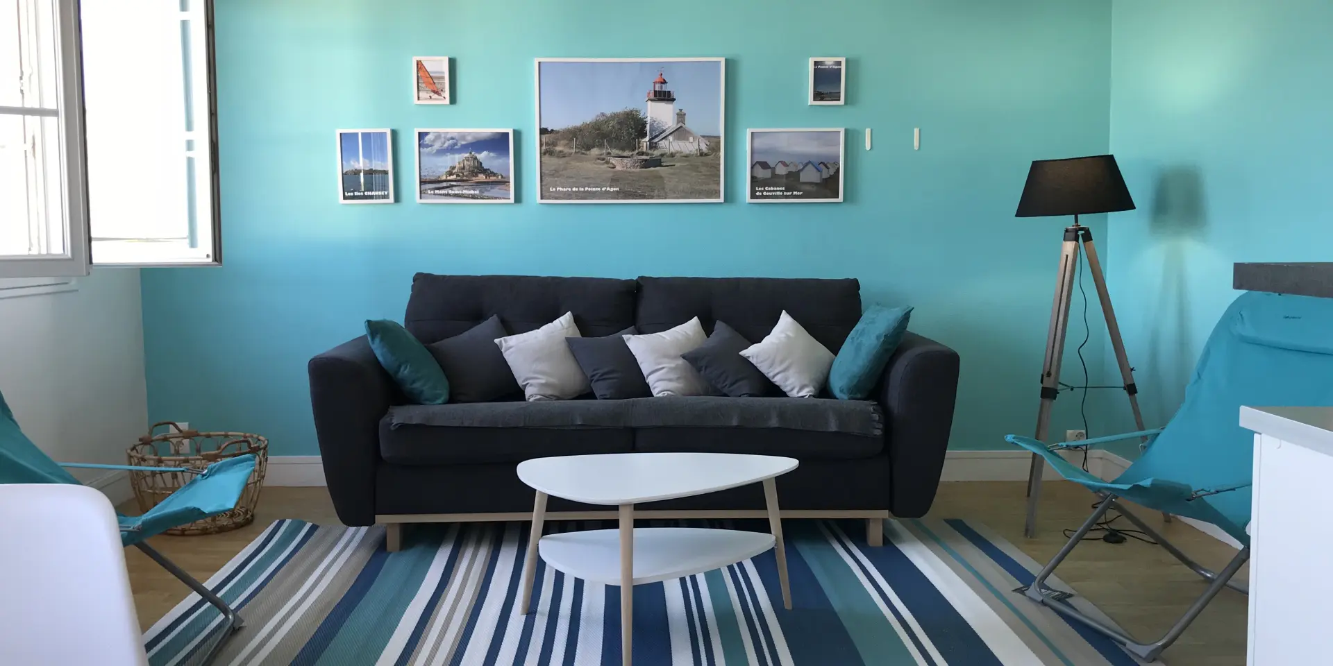 Living room with black sofa, white coffee table, and turquoise walls