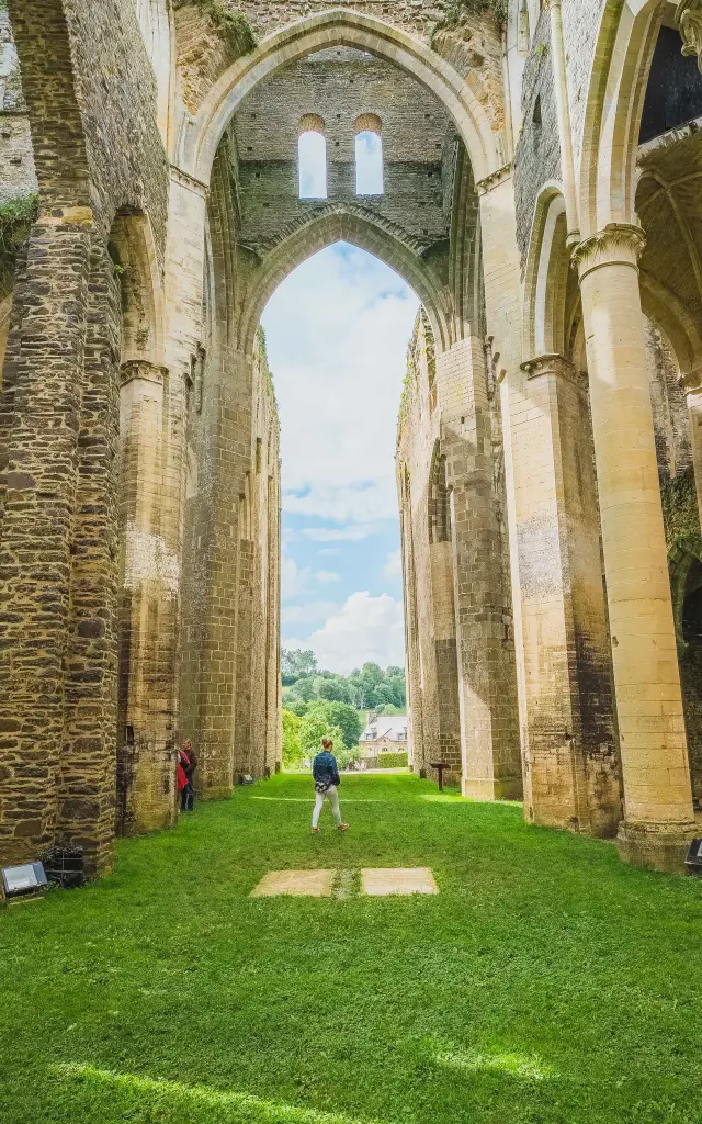Interior of the ruins of Royaumont Abbey with columns and greenery
