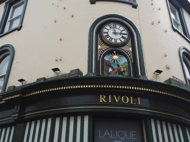 Facade of a store with a clock and a Rivoli sign