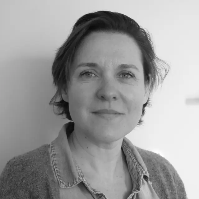 Portrait of a woman with short hair and a plaid shirt