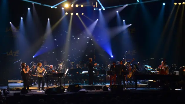 Orchester spielt auf der Bühne mit hellen Scheinwerfern