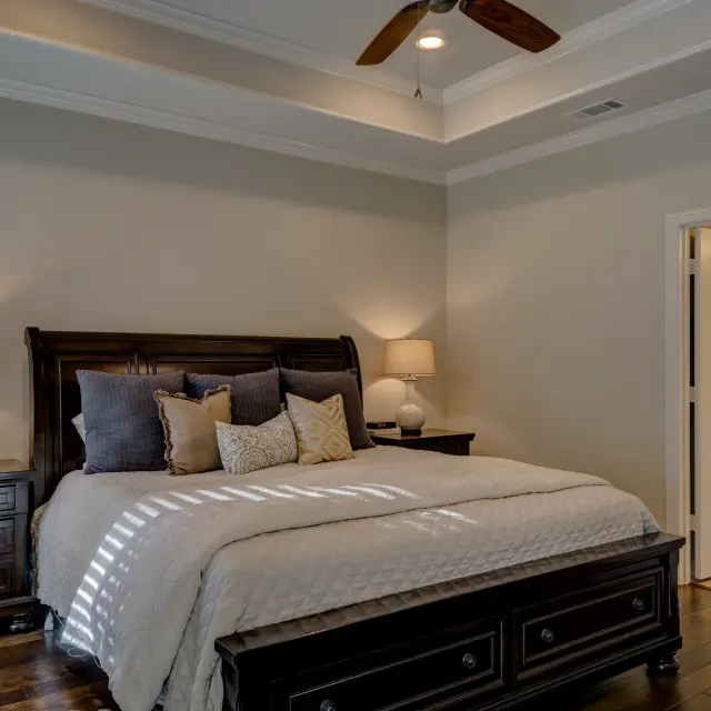 Bedroom with king size bed, two bedside tables and an open door