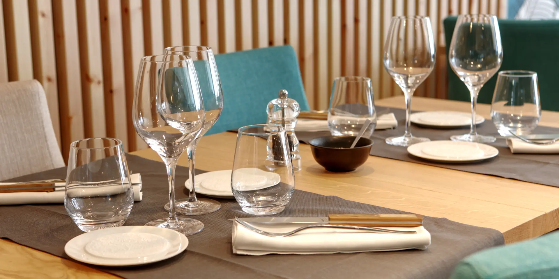 Table set with wine glasses, cutlery, and napkins