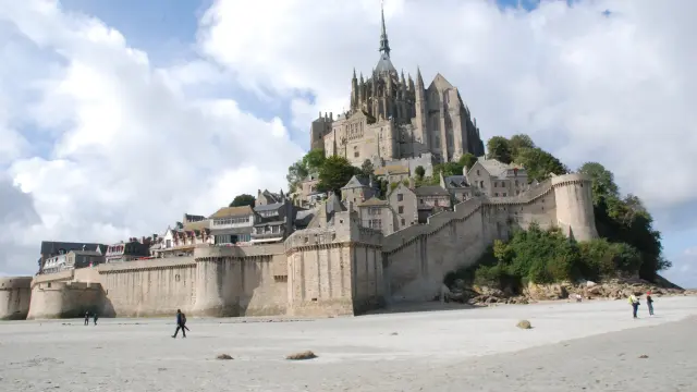 Mont Saint-Michel with visitors on the beach