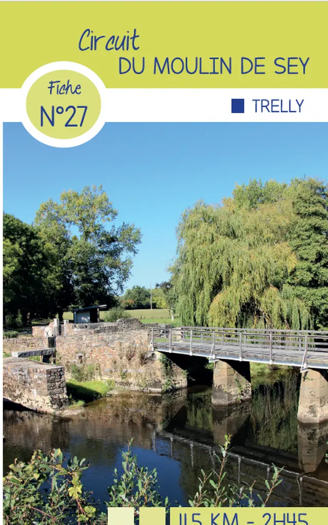 Bridge crossing a river with trees and a blue sky