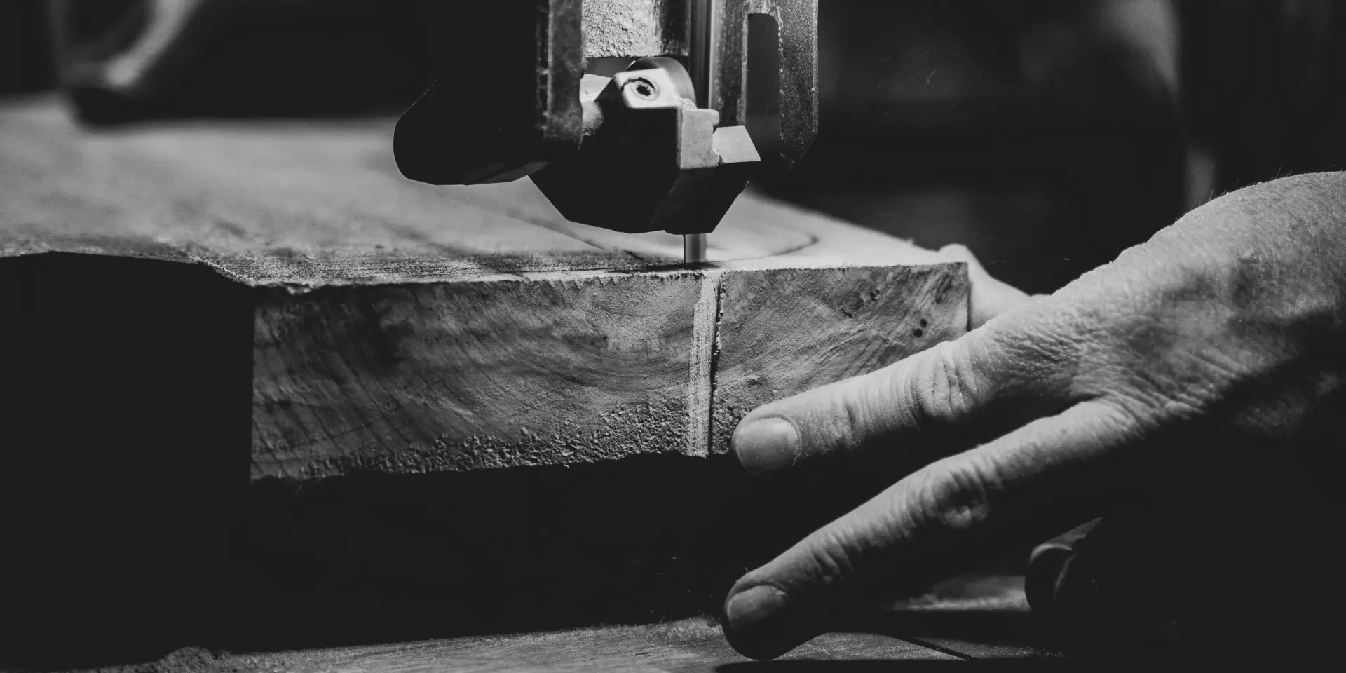 A craftsman uses a machine to carve a piece of wood