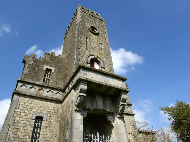 Stone tower with clock and ancient architecture