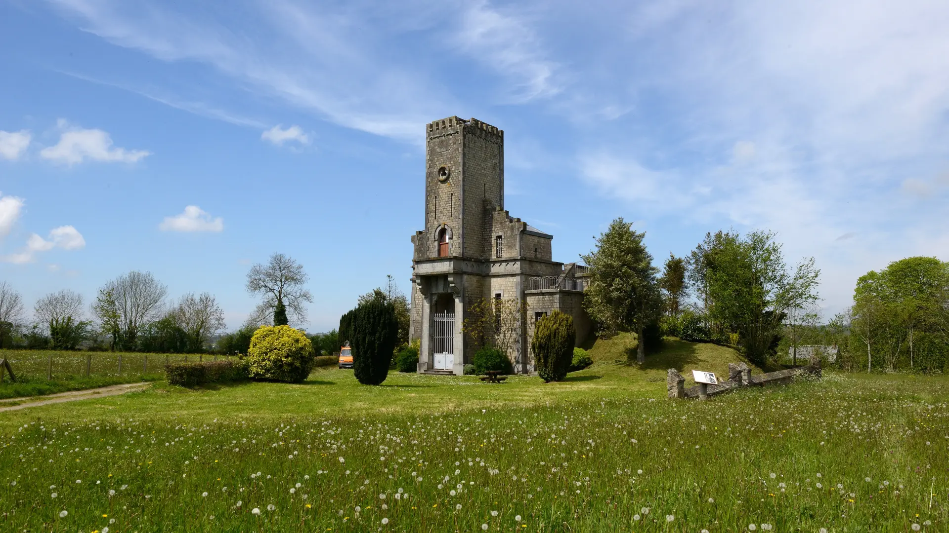 Old stone church with a bell tower and a cemetery