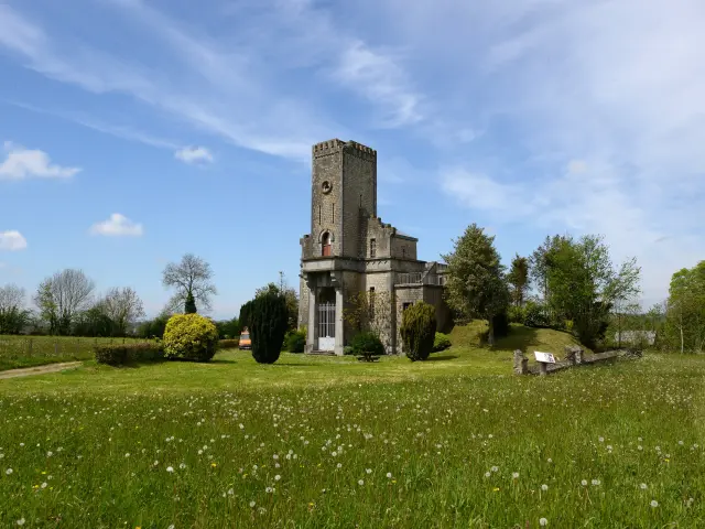 Old stone church with a bell tower and a cemetery