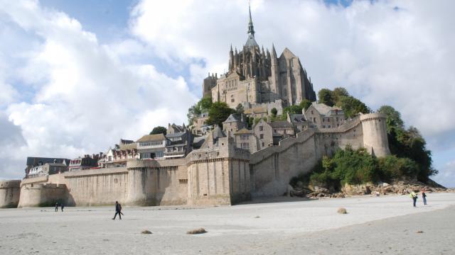 Mont Saint-Michel with visitors on the beach
