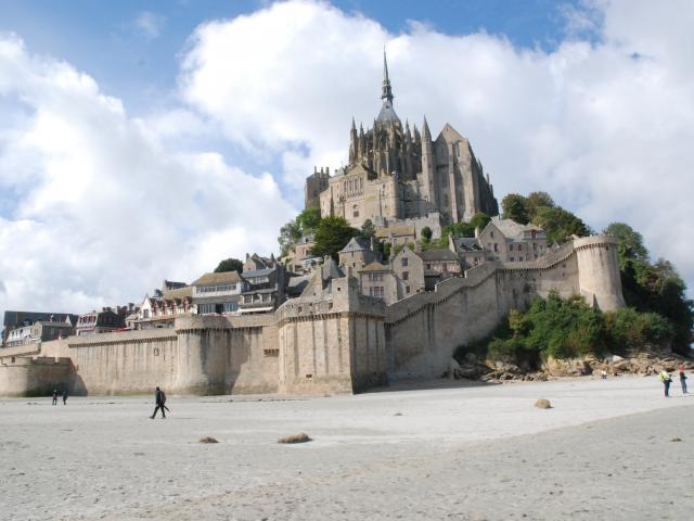 Mont Saint-Michel with visitors on the beach