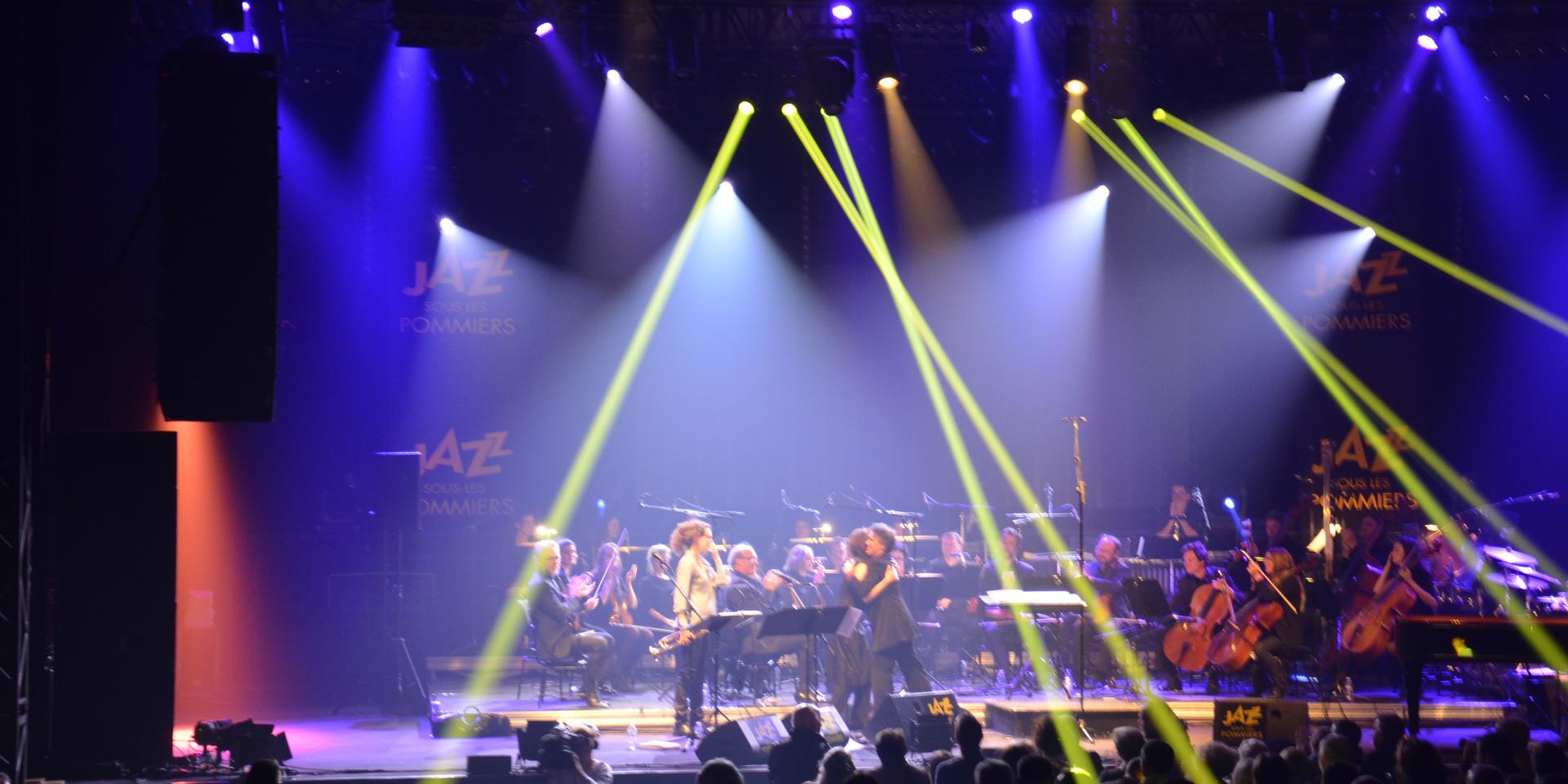 A band performing on stage with colorful spotlights