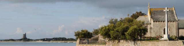Water tower near the coast with rocks and calm water