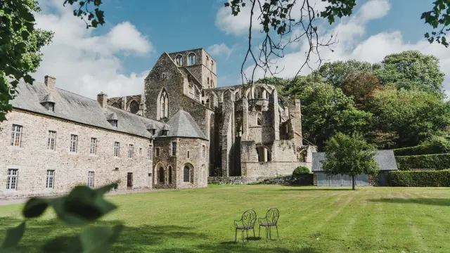 Abbey ruins with benches in a park
