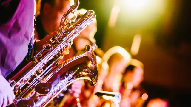 Plusieurs saxophonistes jouent en concert sous les projecteurs