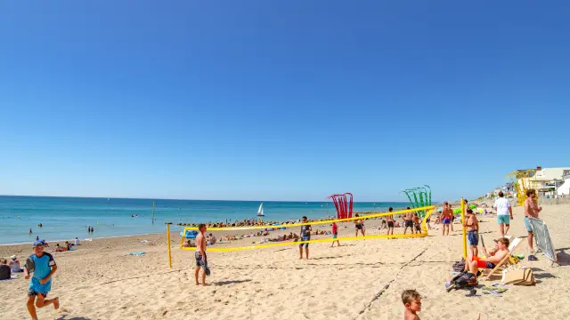 Beach games and relaxation under a clear blue sky