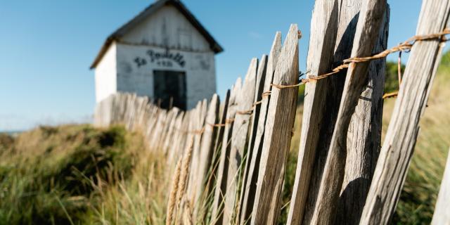 White house with a wooden fence in the foreground