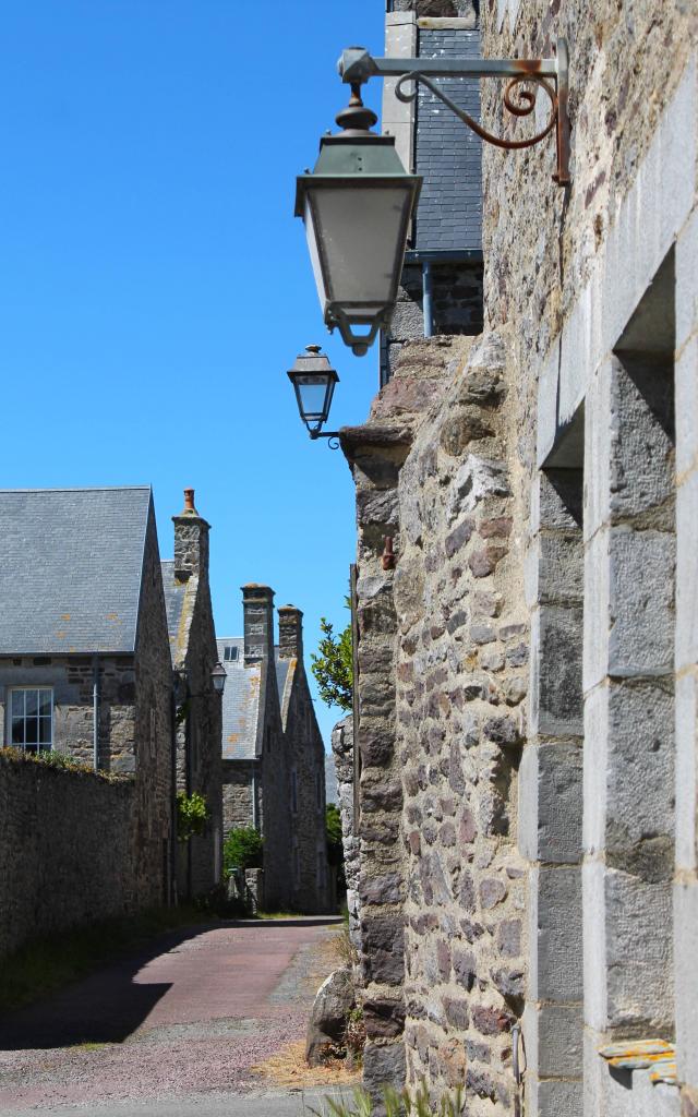Cobblestone street lined with old stone lampposts