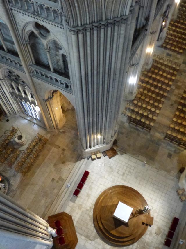 Aerial view of the interior of a cathedral with columns and pews