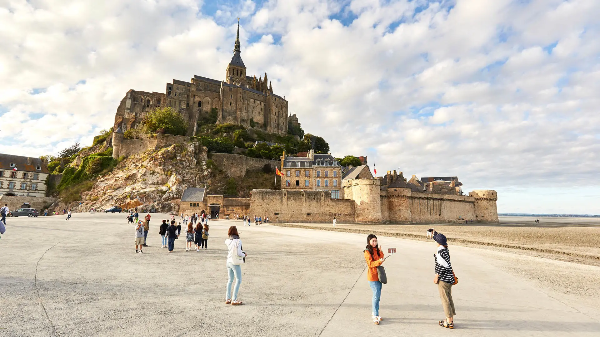 Mont Saint-Michel with visitors on the beach