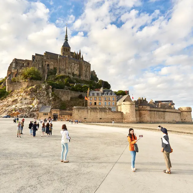 Mont Saint-Michel with visitors on the beach