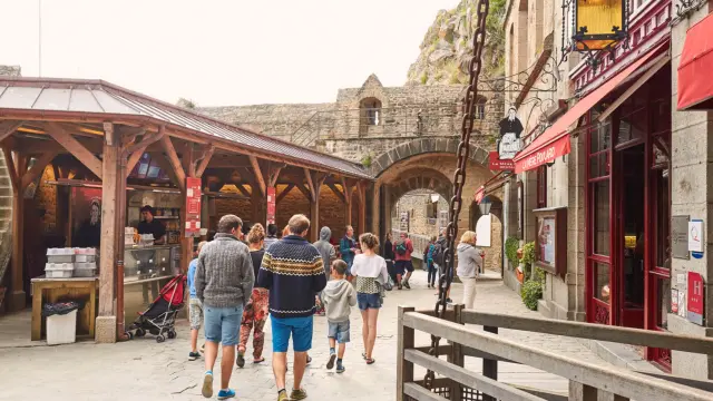 People walking in a shopping street with shops and stalls