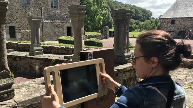 Woman holding a digital tablet in a historical setting