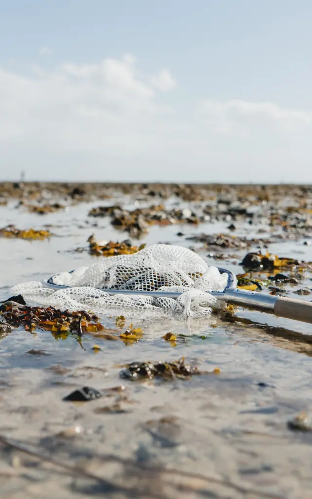 Trash and abandoned fishing net on a beach