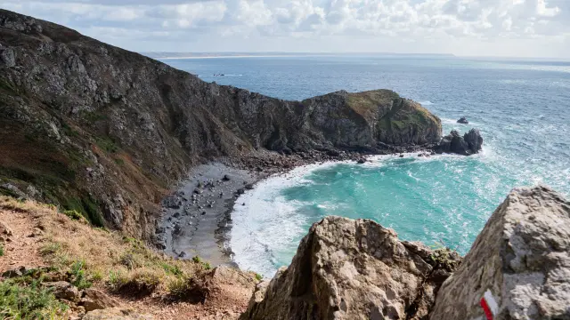 View of a cove with cliffs and a small beach