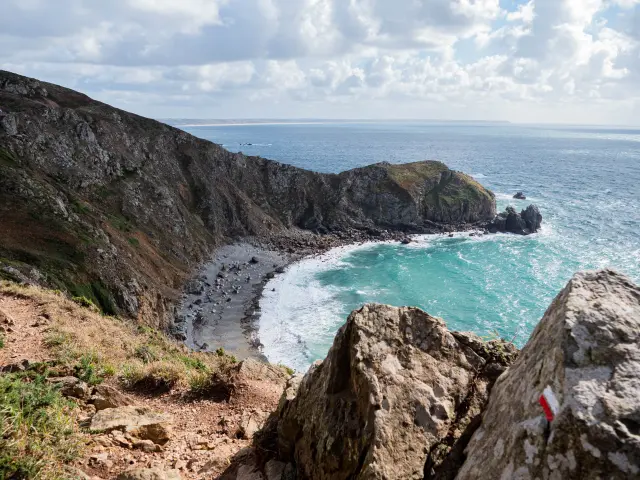 View of a cove with cliffs and a small beach