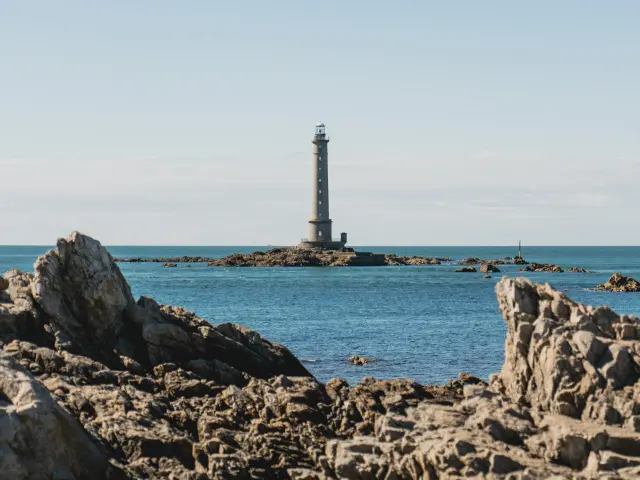 Lighthouse on a small rocky islet in the middle of the sea
