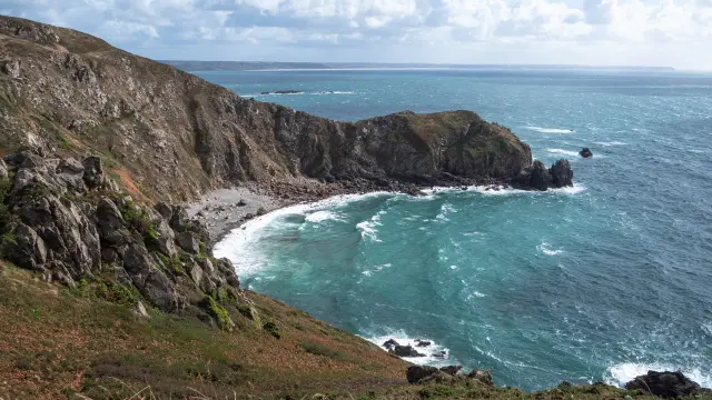 View of a rocky coastline with waves crashing against the rocks