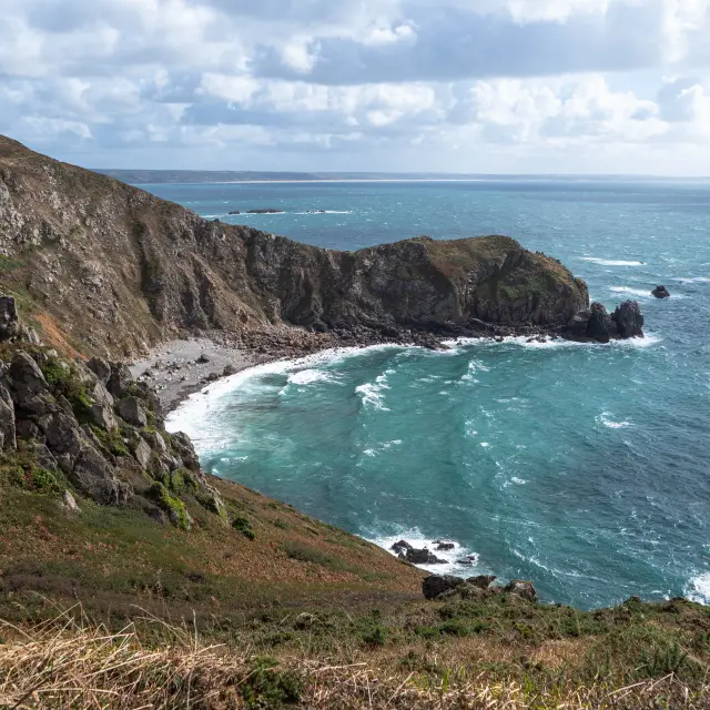 View of a rocky coastline with waves crashing against the rocks
