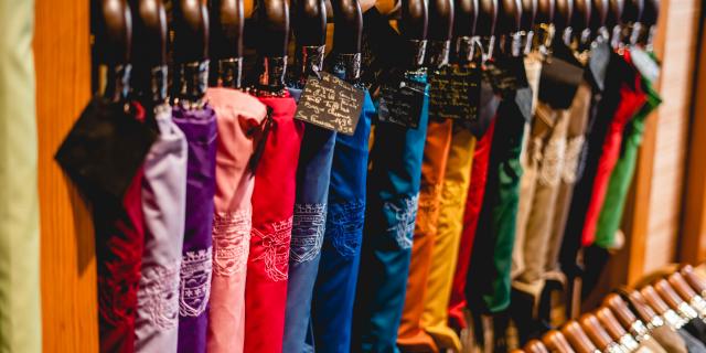 Rack of colorful clothes with patterns and tags