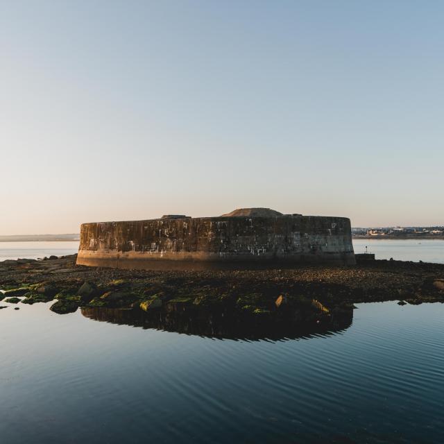 Stone fortress on a rocky islet surrounded by calm water