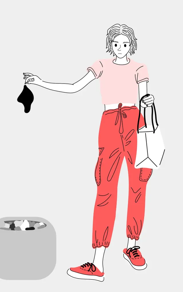 A person holding waste and a plastic bag near a sorting bin