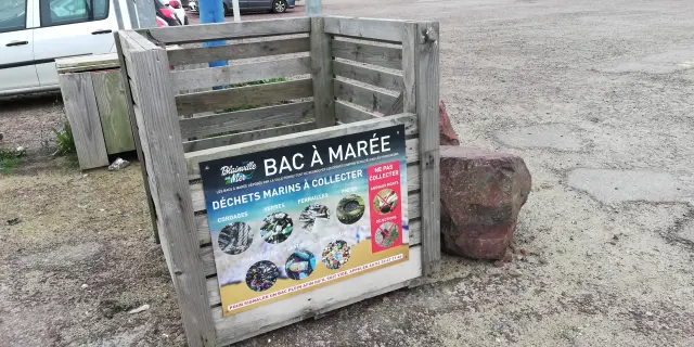 Wooden bin for marine waste with descriptive sign