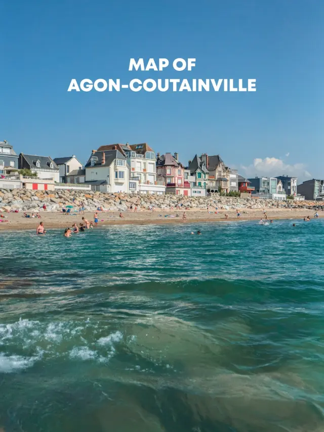 Beach with people swimming and colorful houses in the background