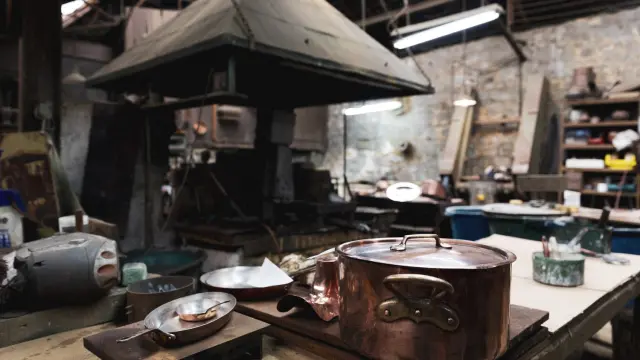 Rustic kitchen with copper pot and wood stove