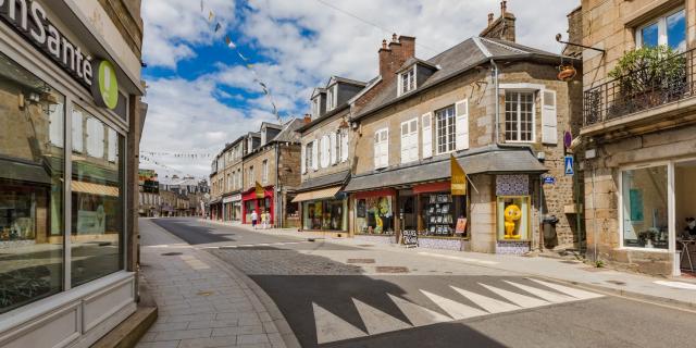 Shopping street with shops and stone buildings