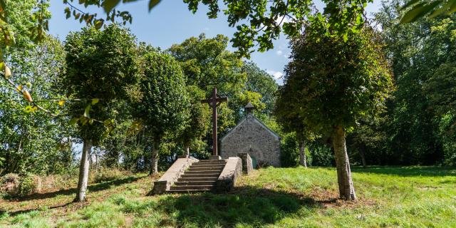Stone chapel with a calvary at the top of a staircase
