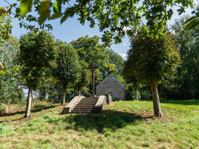 Stone chapel with a calvary at the top of a staircase