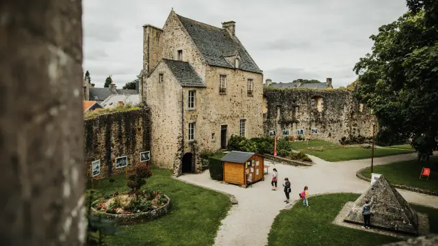 Medieval castle with garden and people walking