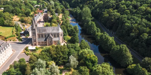 Stone church with a winding river and an adjacent road