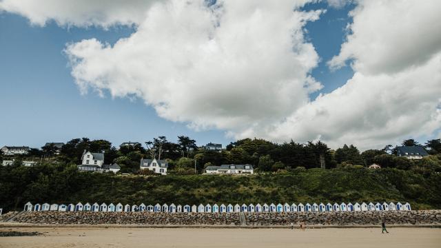 Cabanes de plage blanches alignées sur une plage de sable à Carteret