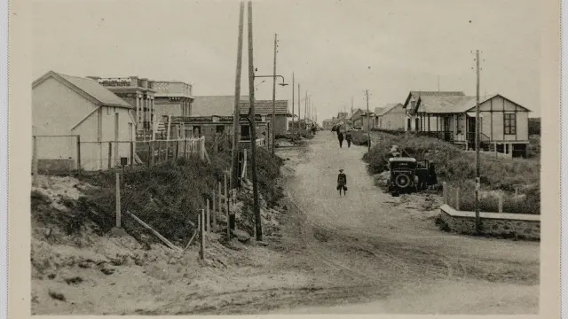 Village street with old houses and a child walking