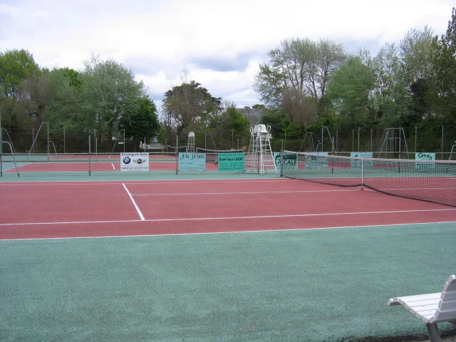 Outdoor tennis court with trees in the background