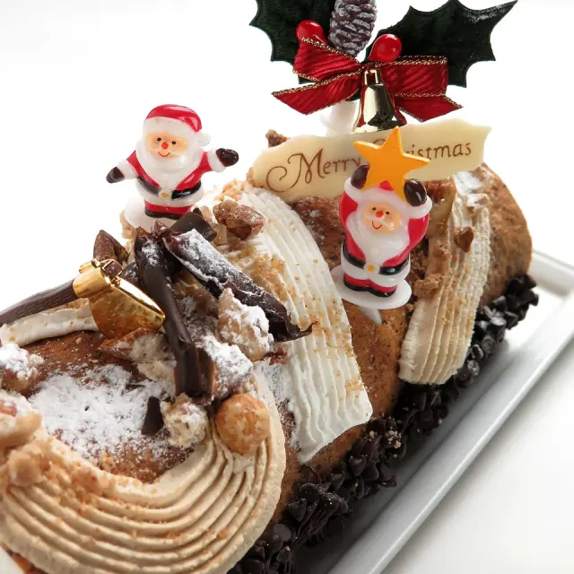 Christmas Yule log decorated with Santa figurines and Christmas ornaments