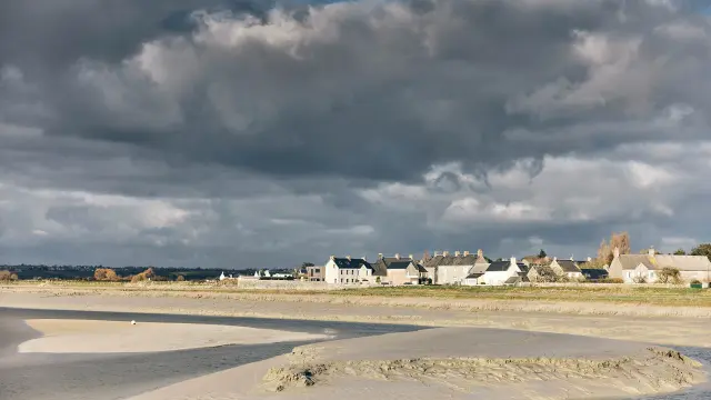 Coastal village with white houses and a cloudy sky