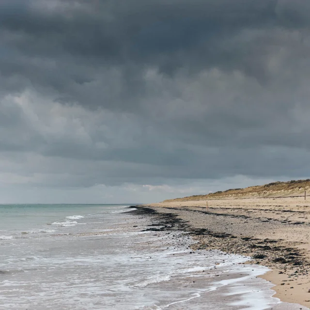 Beach with waves and a cloudy sky